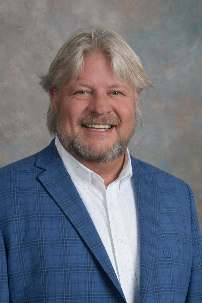 Man with white hair smiling